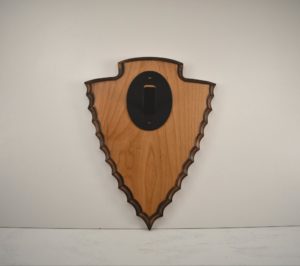Arrowhead plaque with skull hanger.
