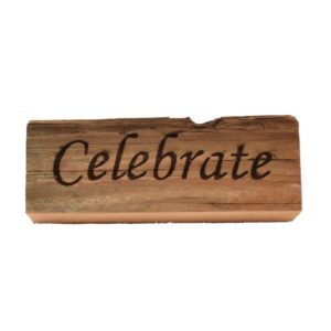 Reclaimed barn wood block sign that reads, "Celebrate".