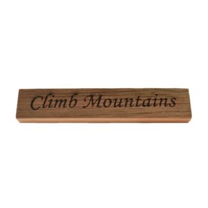 Reclaimed barn wood block sign that reads, "Climb Mountains".