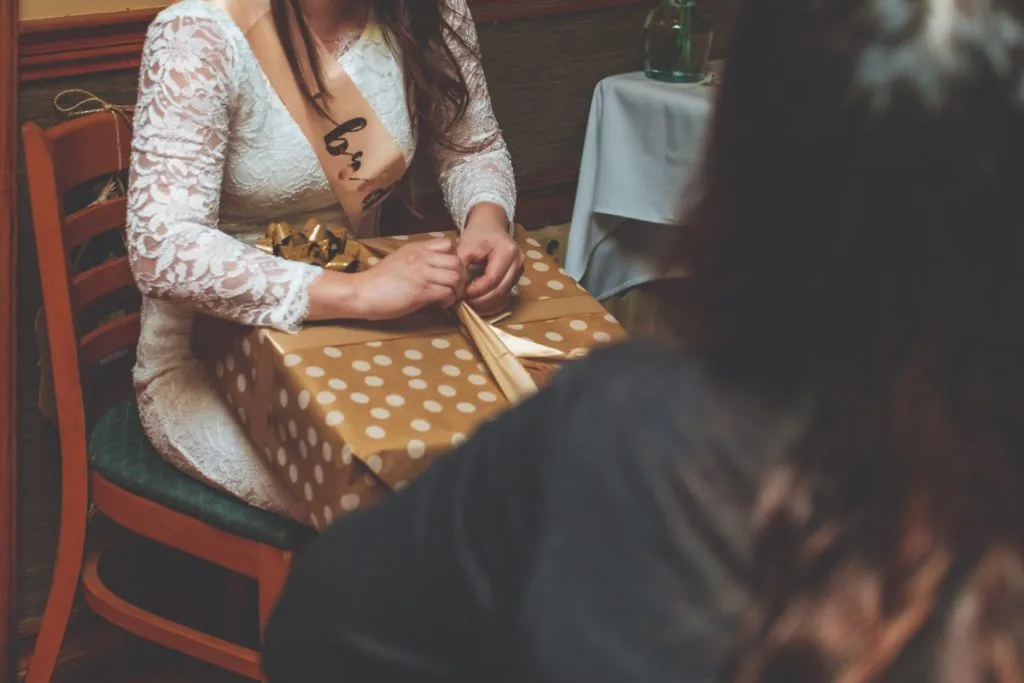 Bride opening her wrapped gift package